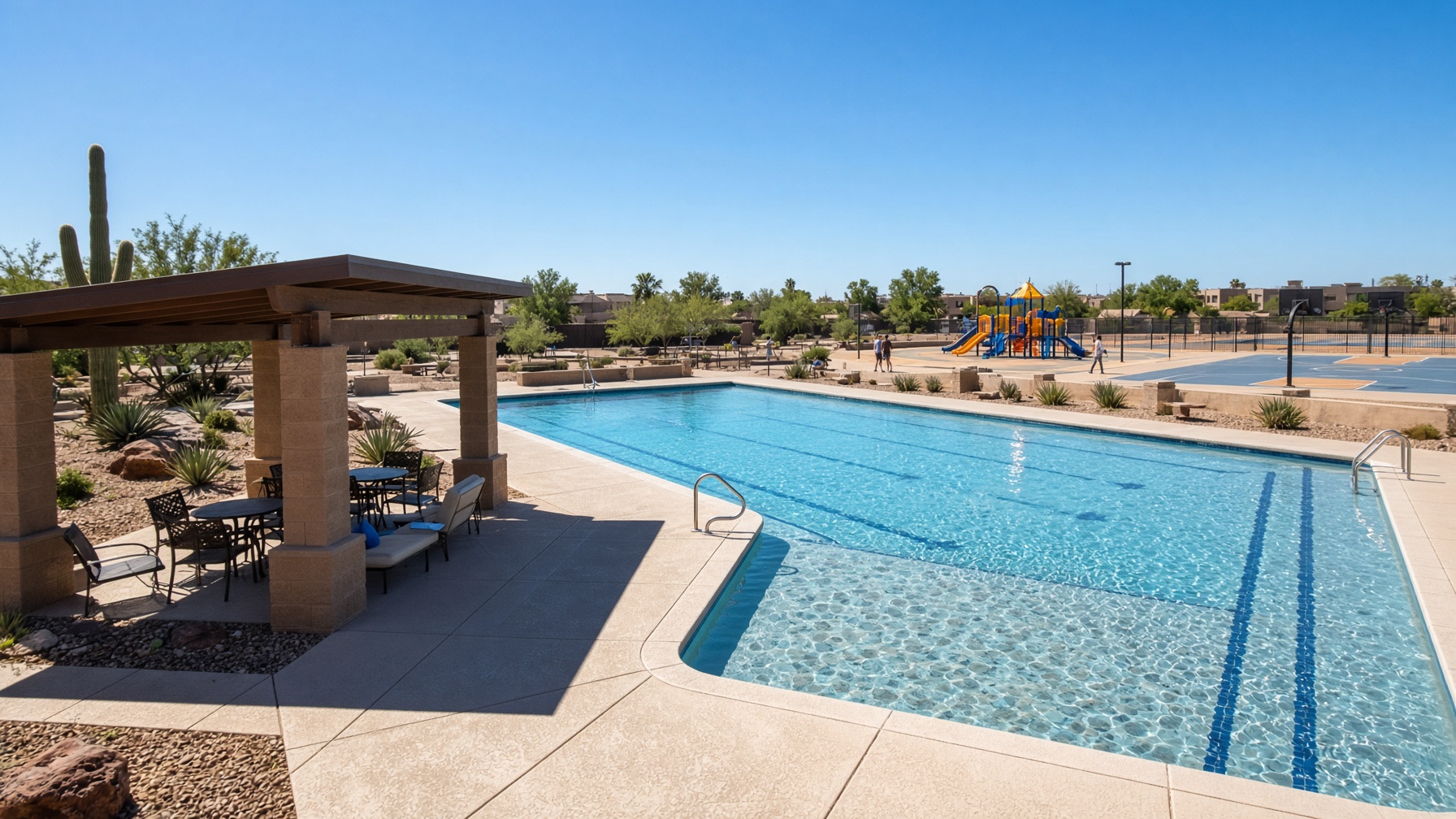 Resort-style community pool, ramadas, and play space on a bright Gilbert afternoon